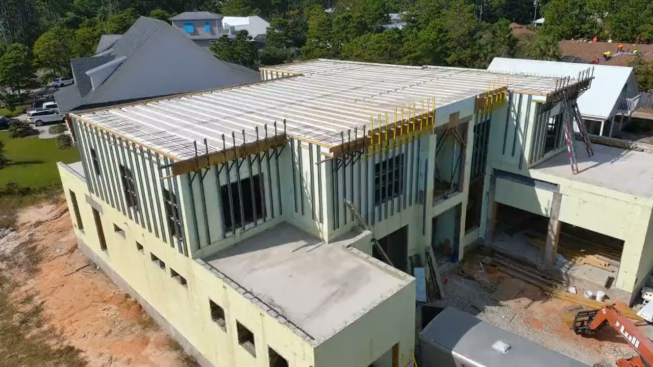 Aerial view of a two-storey ICF house shell with the floor deck formed and bracing in place.